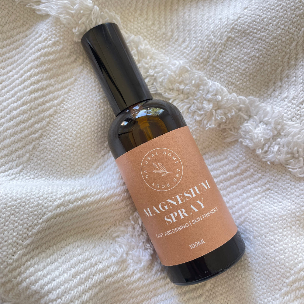 Adults Magnesium Oil Spray on a white blanket.