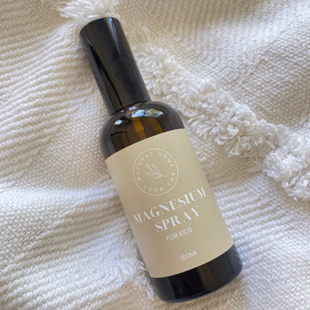 Kids Magnesium Oil Spray on a white blanket.